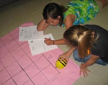 Texas students solve a Bee-Bot problem.